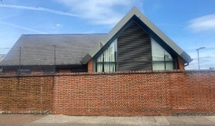 Fig. 100: A modern extension to Beatrix Potter school. The detailing and the form of the gable add interest above the high school walls.