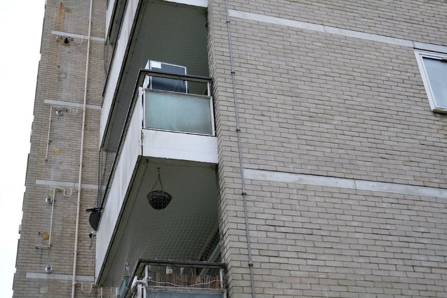 Fig. 44: A detail of the balconies, white brick, and floor plate band