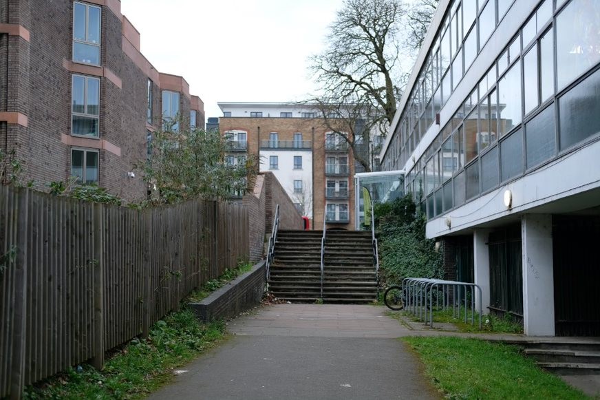 Fig. 104: The channel between Chadwick Hall and 166 Roehampton Lane as the land drops down from the lane to Downshire Field