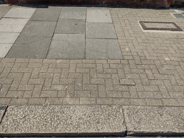 Fig. 76: Existing paving is a mix of pavers and bricks with granite kerbs