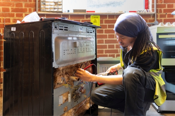 A worker at Rework London fixes a household item