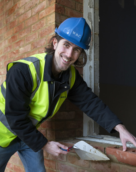 Aydin Dikerdem laying a ceremonial brick